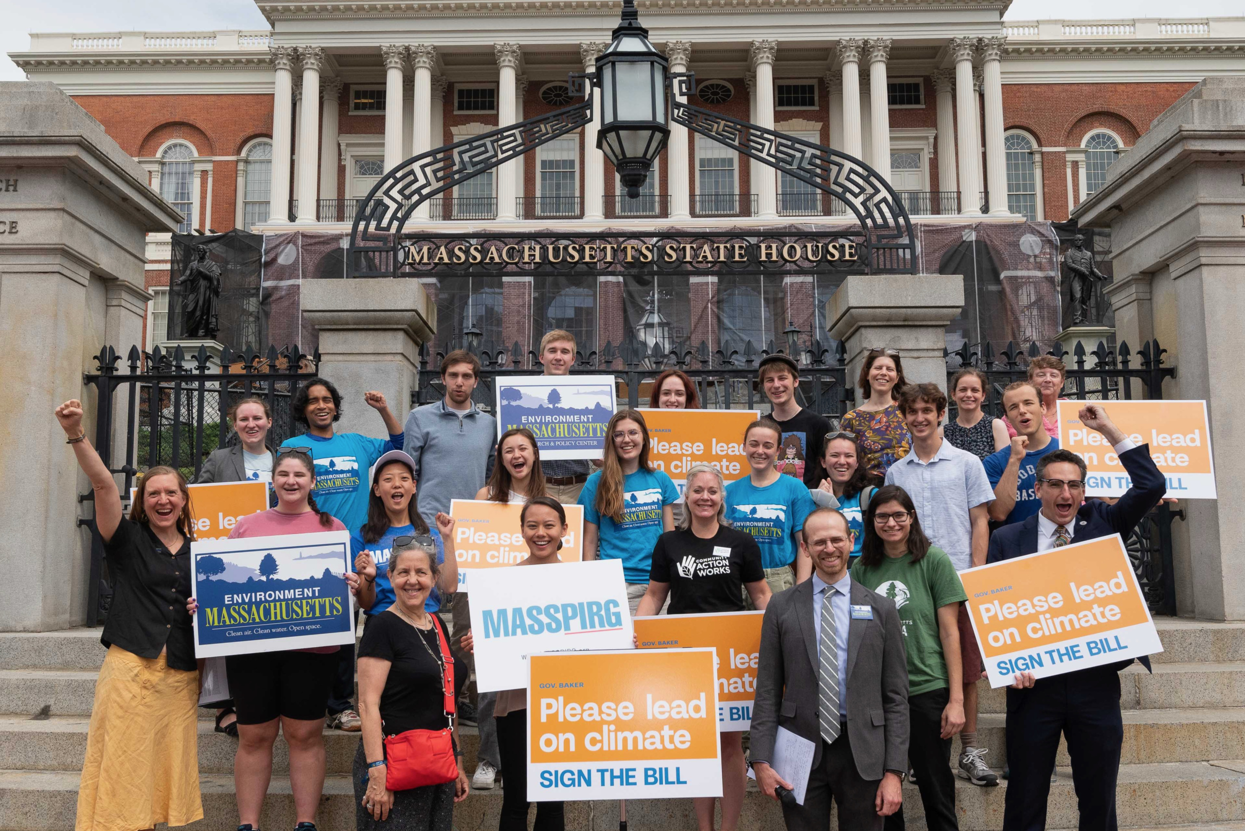 activists rallying for climate legislation in front of the Massachusetts State House